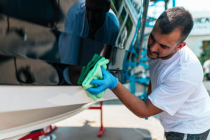 Boat maintenance - A man cleaning boat with cloth | Eco-Friendly Boating | Marinalife