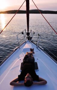 Man laying on deck by Alex Block | Captain's Tips yacht management | Marinalife